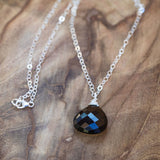 Faceted smoky quartz necklace laid beautifully, exuding high vibrational energy and elegance.