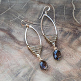 marquise style smoky quartz earrings laid beautifully on wooden table