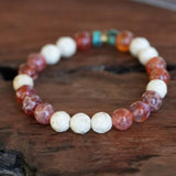 Women's bracelet for grounding and protection, elegantly displayed on a wooden table.