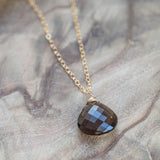 Smoky Quartz High Vibration Gold Necklace featuring calming and healing energy, laid out beautifully for display.