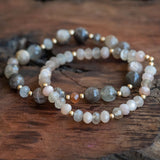 Peach Moonstone, Rainbow Moonstone, and Sunstone bracelet set laid beautifully on a wooden table, radiating inner peace, joy, and self-love.