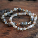 Peach Moonstone, Rainbow Moonstone, and Sunstone bracelet set laid beautifully on a wooden table, radiating inner peace, joy, and self-love.