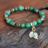 Heart and Soul Bronzite, Jade, and Prehnite Healing Bracelet laid beautifully.