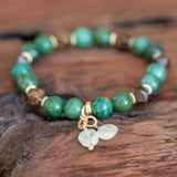 Heart and Soul Bronzite, Jade, and Prehnite Healing Bracelet laid beautifully.