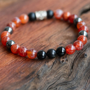 Men's boho stacking bracelet with healing stones, placed on a wooden table, laid beautifully.